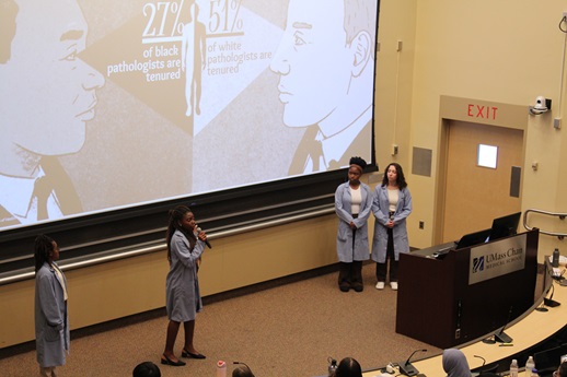 Four students are presenting their project.