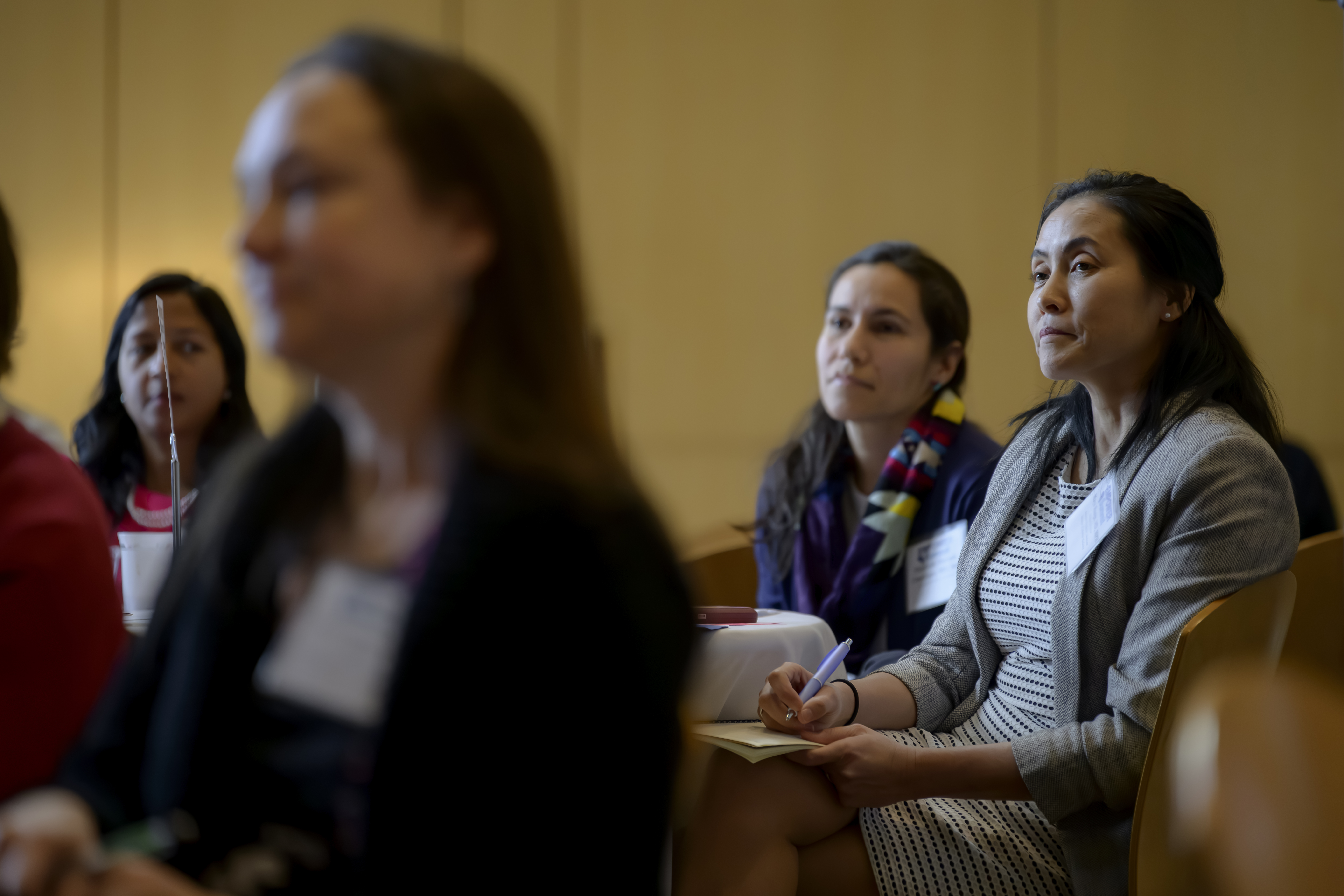 four women sitting at tables