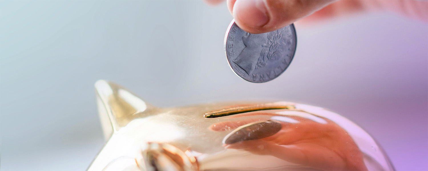 Putting coin in piggy bank