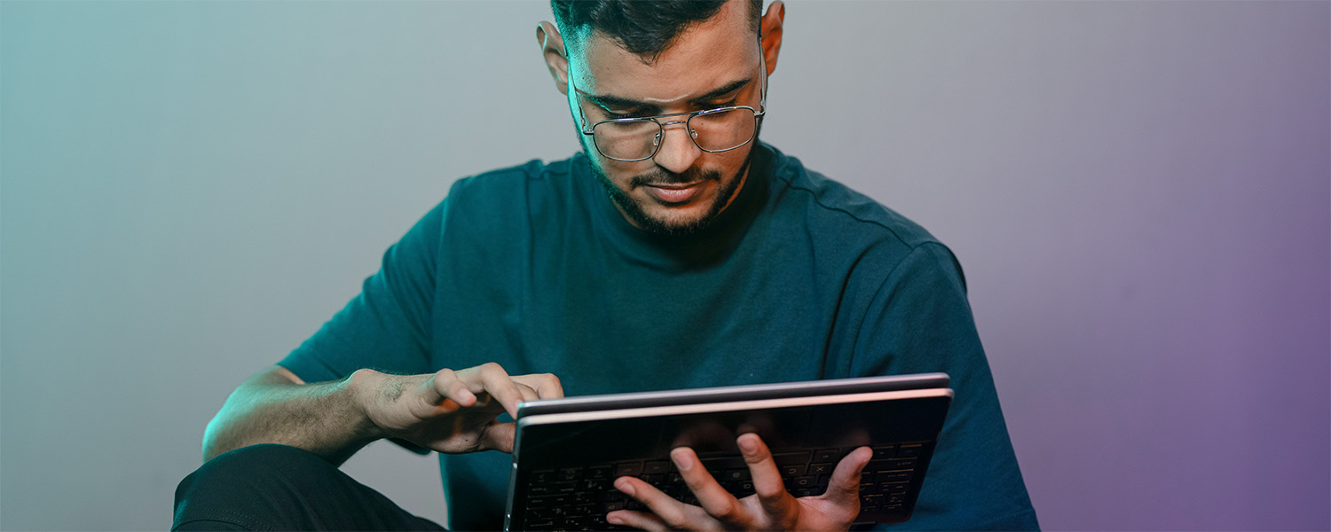 Young man scrolling on tablet