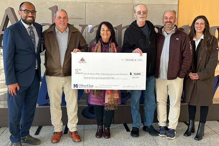 Kevin Brisette, second from left, joined by Kerri Appleton&rsquo;s parents, brother and a close friend, presents an honorary check to Neil Marya, MD, first from left.