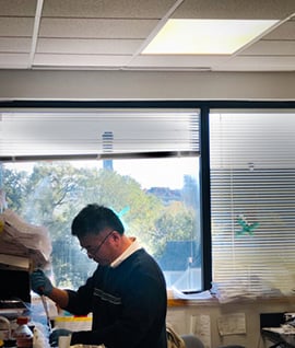 Image shows a man working at a research bench