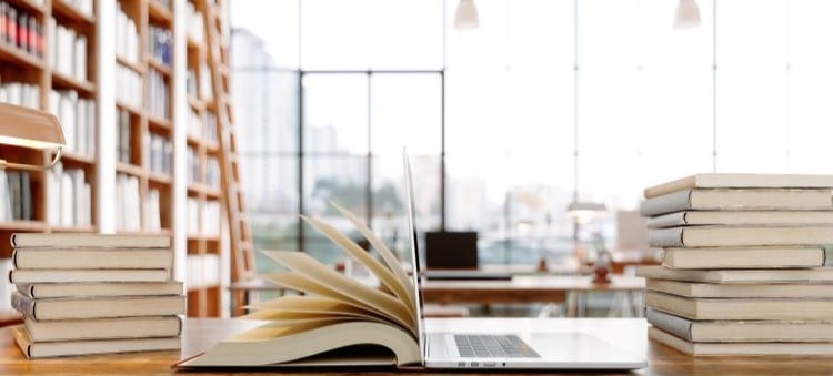 open laptop on a table in a library