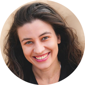 A headshot of Galvan Pena Silvia with a broad and warm smile. She has a long wavy dark hair and wears a small nose ring. 