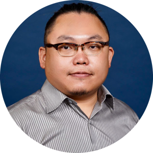 A headshot of Meng-Ju Wu, wearing glasses and a neatly trimmed goatee, wearing a striped shirt, set against a solid blue background