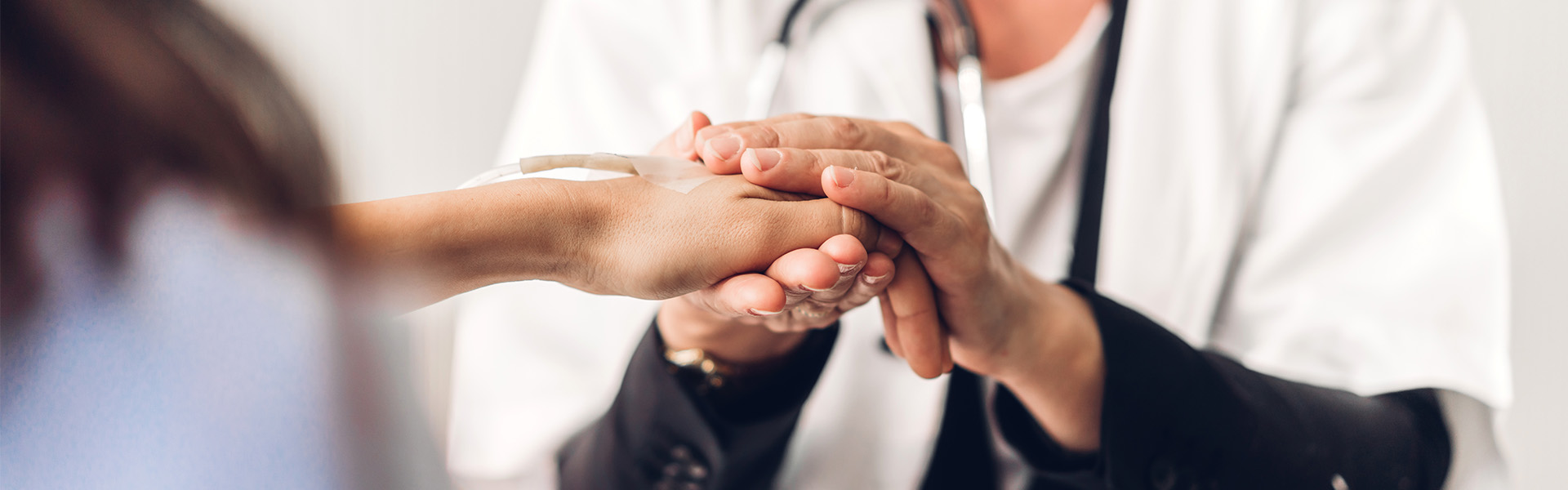 Doctor holding patient's hand