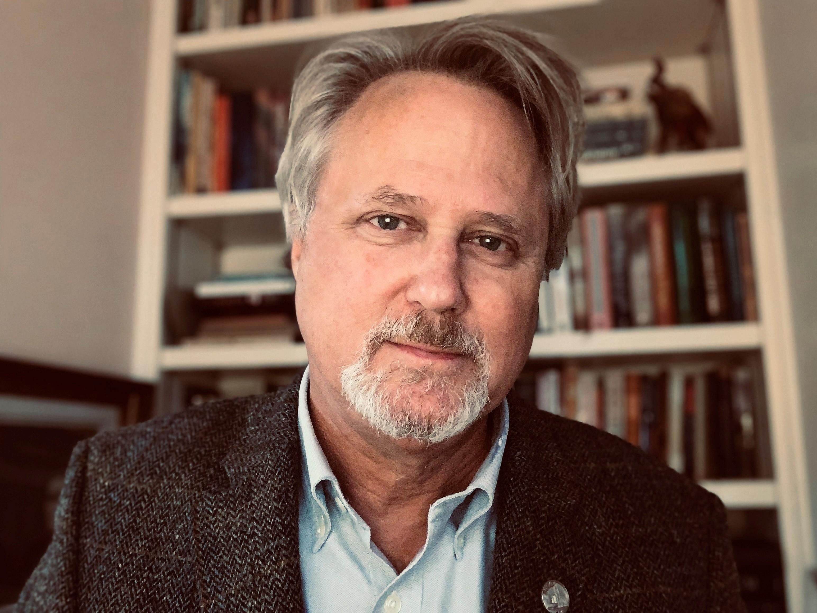 white man with greying hair and goatee