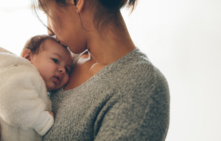 mother kissing baby's head