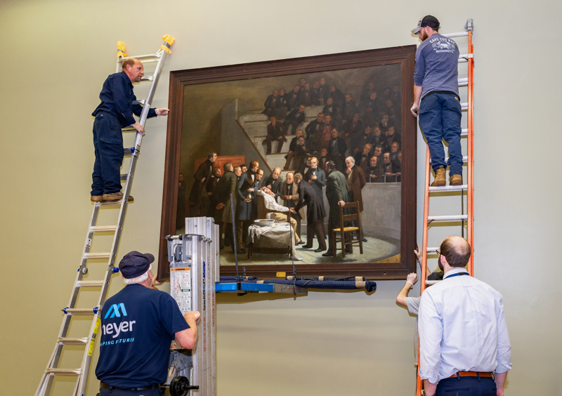 The historic painting &ldquo;The First Operation Under Ether,&rdquo; by Robert C. Hinckley, being installed in the Lamar Soutter Library in January. It is on long-term loan from  Boston Medical Library. The painting depicts a crowded surgery suite with a patient being administered anesthesia.