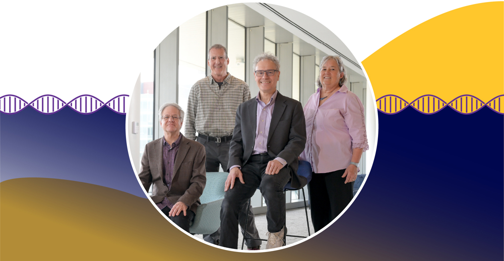 A photo of RNA Therapeutics Institute founders Phil Zamore, Craig Mello, Victor Ambros and Melissa Moore. They are standing in a hallway in the Paul J. DiMare Center. Zamore and Ambors are seated in the foreground, with Mello and Moore standing behind them. 
