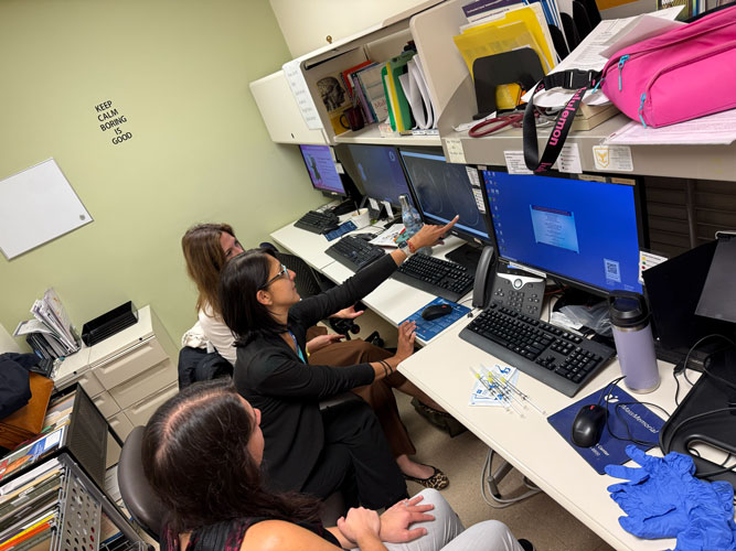 MS Fellowship Team reviewing imaging scans on the computer