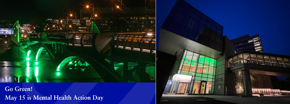 building with lobby lights lit up green bridge over water at night lit up green