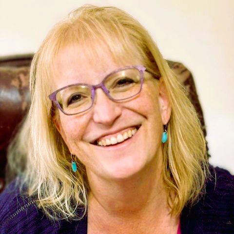 white woman with blonde hair and glasses