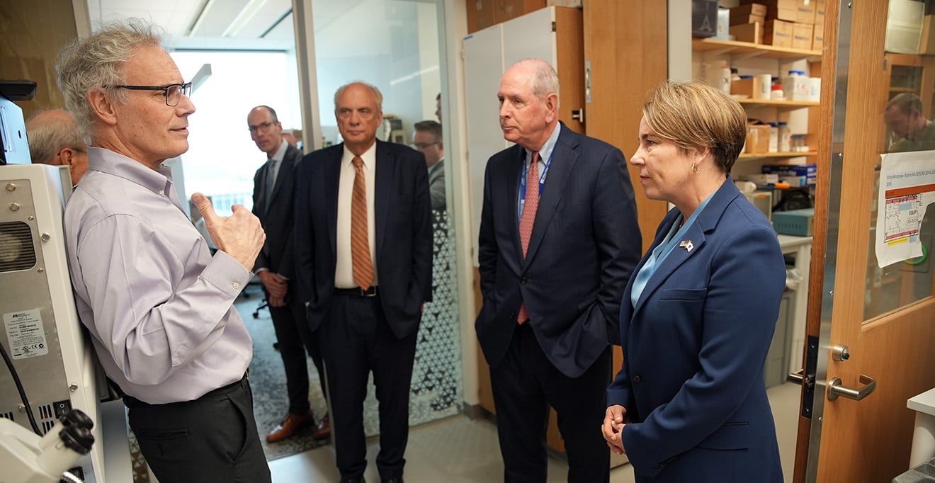 Victor R. Ambros, PhD (left), leads (right to left) Governor Maura Healey, Chancellor Michael F. Collins and Worcester Mayor Joseph M. Petty, on a tour of his lab in the Paul J. DiMare Center