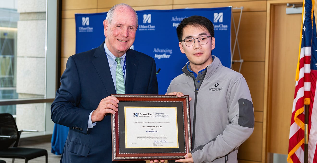 Photo of Chancellor Michael F. Collins presented the 2025 Chancellor&rsquo;s Award to PhD candidate Xuhang Li.