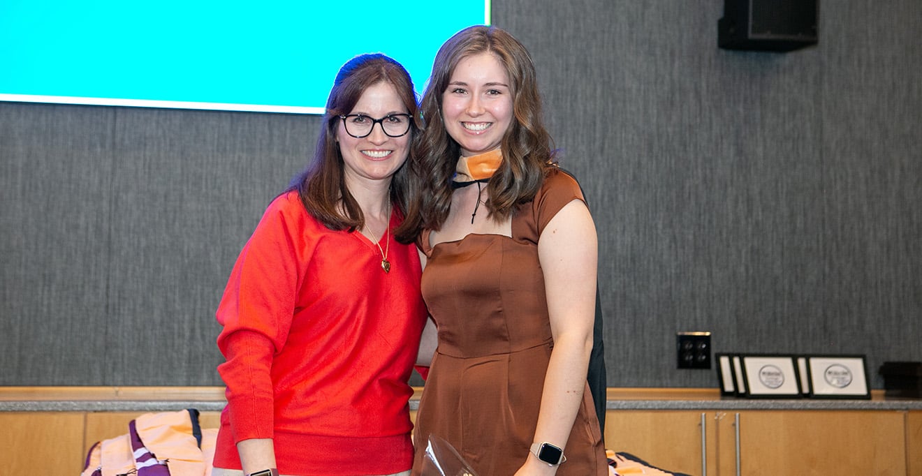 Photo of Danielle Hebert, DNP, MBA, MSN&rsquo;07, ANP-BC, assistant professor of nursing and coordinator of adult-gerontology primary care nurse practitioner track, hooded her daughter, Julia Hebert, MS, BA, FNP-C, a DNP student in the Family Nurse Practitioner Track. 