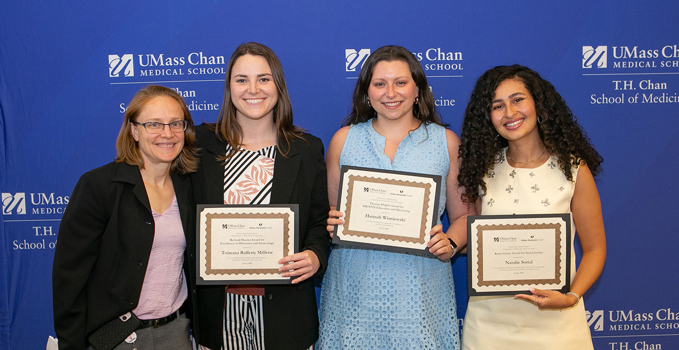 Photo of Anne Garrison, MD, presented awards to Toireasa Rafferty-Millett, Hannah Wisniewski and Natalie Sorial