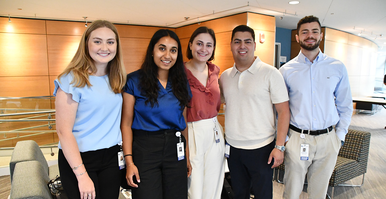 Madeleine Schwede, Raiya Suliman, Phoebe Lasic-Ellis, Kareem Hamada and Michael Ayoub head into the Albert Sherman Center Auditorium to hear Chancellor Collins speak.