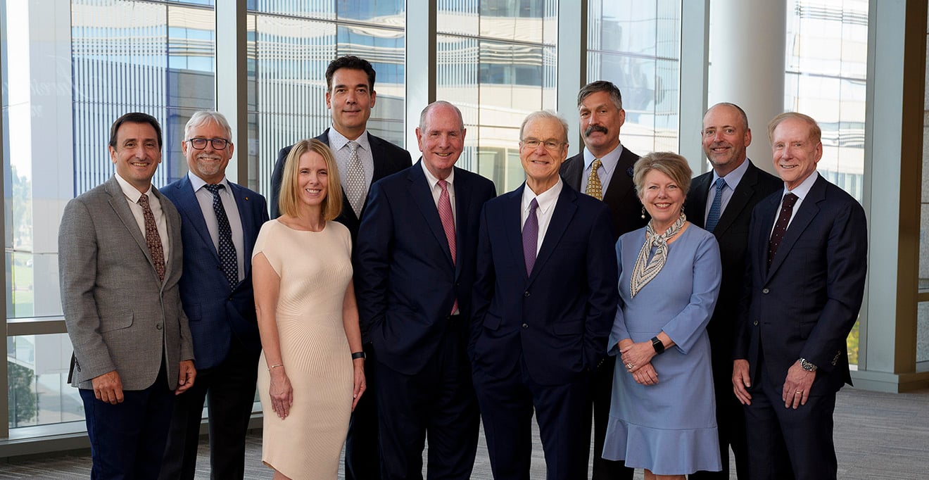 The nine faculty members honored and invested as endowed professors stand with Chancellor Michael F. Collins (center). From left to right: Christopher M. Sassetti, PhD; Craig L. Peterson, PhD; Stephenie C. Lemon, PhD; Richard I. Gregory, PhD; Terence R. Flotte, MD; Oliver Rando, MD, PhD; Anne C. Larkin, MD; Paul Thompson, PhD; and Kenneth L. Rock, MD