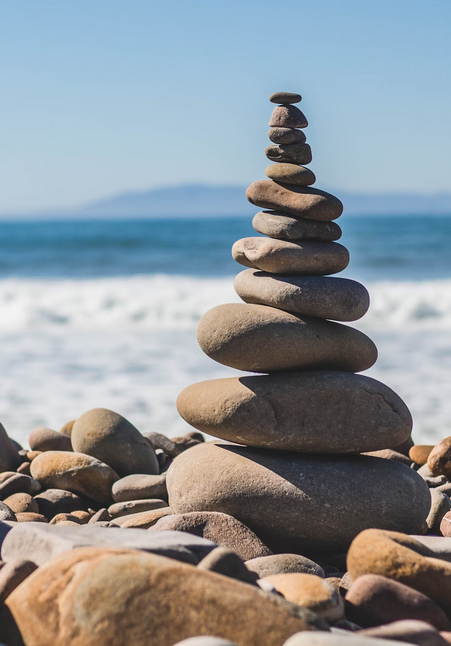 Stones stacked upon one another on beach